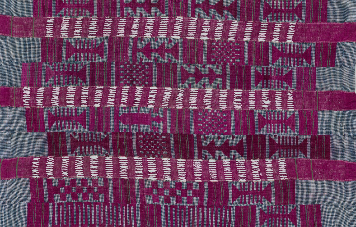 Work of cotton and silk: purple, white, and black in repeating linear patterns.
