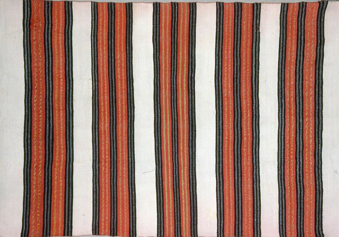 A work made of wool, single interlocking tapestry weave; two selvages present.
