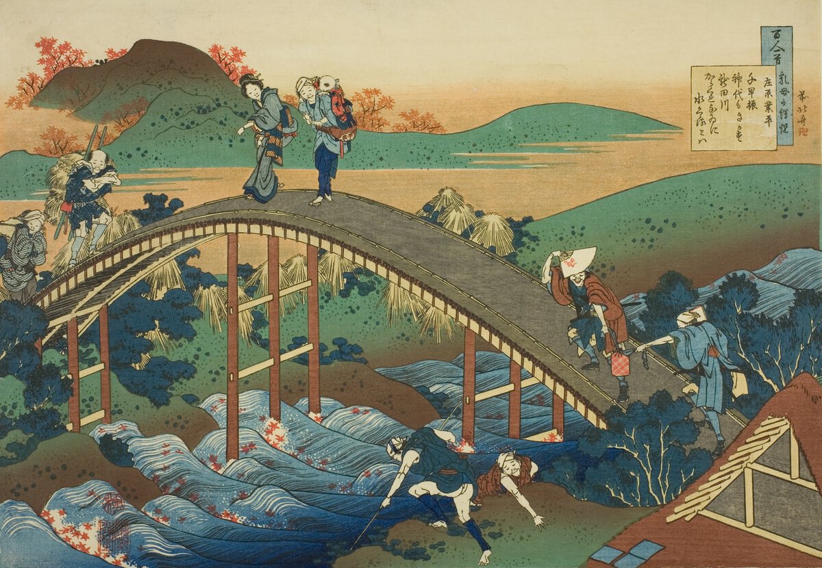 Group of of people crossing a bridge over a river with a group of green hills in background.