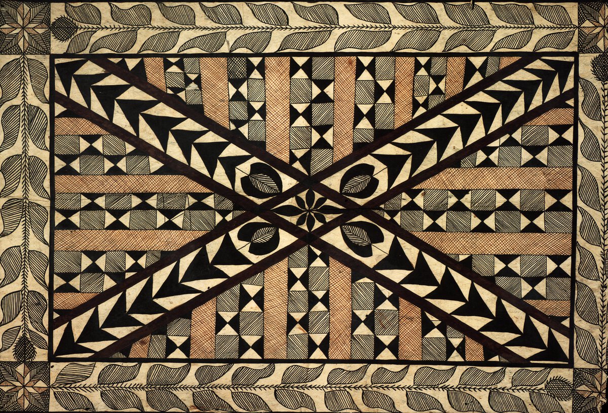 Textile in brown, beige, gray, and black grid pattern overlaid by an X.